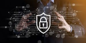 A security lock icon positioned across the web, a businessman’s silhouette in the background, emphasizing online security and protection.